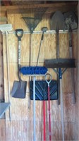 N wall of tools:  handled brush, square shovel, ya