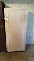 White wooden storage cabinet with contents.