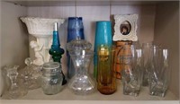 A collection of glasses and cherub vase