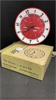 Electric Lux red wall clock in orig box. Powers on