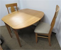 Wood drop leaf table with (2) chairs. (1) Is