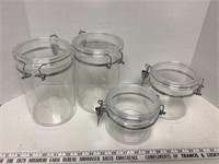 4 assorted sized plastic canisters w/ locking lids