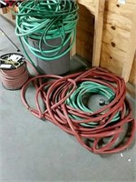Lot of water hose and trash barrel