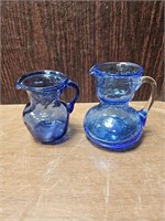 Two Mini Blue Glass Pitchers - One Crackle Glass
