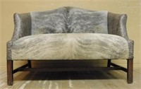 Cowhide and Leather Upholstered Walnut Leg Settee.