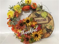 Fall themed faux floral wreaths and welcome sign