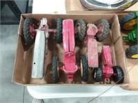 assortment of broken toy tractors