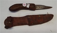 Vintage knife with leather sheath. Measures 8.5"