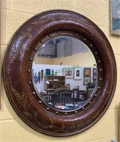 Large round wall mirror with a beveled glass