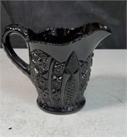 Black glass creamer approx 4.5 inches tall