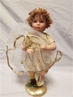 Gold trimmer doll figurine