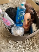 Bin with bathroom items and mannequin head