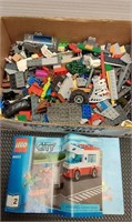 Assorted legos and a Lego book. The book Is not