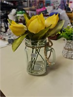 Yellow flowers in glass jar