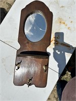 Hat Rack with cracked mirror.