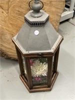 Lantern with glass and latch. Has flowers and
