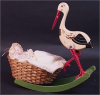 A painted wood figurine of a stork with
