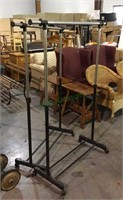 Two adjustable height clothes racks on wheels -