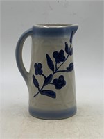 Vintage glazed crock pitcher with blue flower