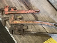 Set of three pipe wrenches. Two are 24” and one