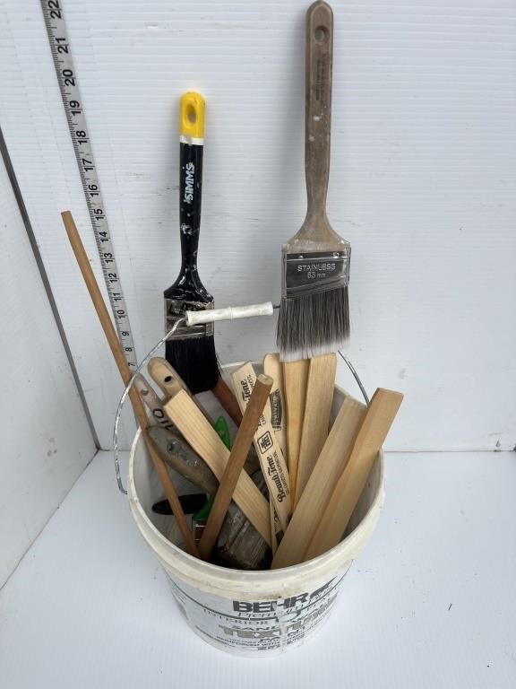 Pail of paint brushes, misc