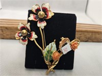 2- ENAMEL LIKE BROOCHES WITH FLOWERS