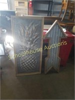 Large pineapple sign and lighted arrow sign