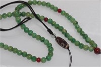 Green beads with a Zi pendant