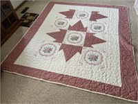 Hand made quilt. Appears to be machine quilted,