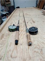 2 fishing poles with reels and lines.