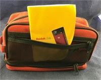 Kodak Zi8 Video Camera With Accessories On Red