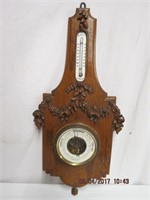 Barometer in carved oak frame 21H 10" across