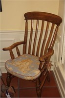 Antique wooden armed chair with cushion