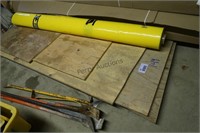 Roll of Yellow Plastic Sheeting and Plywood