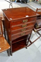 An antique sheet music or file cabinet,