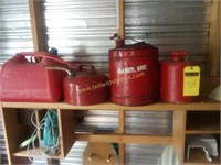 3 metal and 1 plastic gas cans