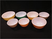Seven Pyrex mixing bowls including primary yellow