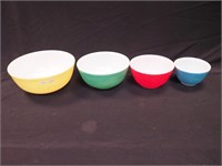 Four nesting Pyrex mixing bowls in primary colors