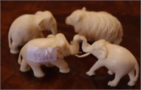 Four small carved elephants and one bear