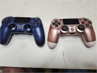 Play Station wireless controllers, blue and pink.