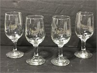 Four white wine stemmed glasses