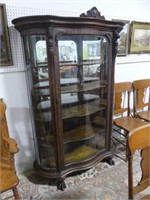 ANTIQUE ORNATE OAK SERPENTINE GLASS FRONT CURIO