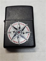Zippo lighter with Marlboro compass rose logo.