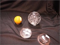 Three paperweights: one is ball-shaped with