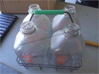 Four farm fresh glass milk jugs with carrier