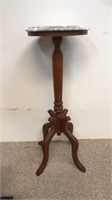 Tall mahogany plant stand with a marble top