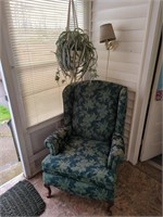 Green chair with hanging faux spider plant