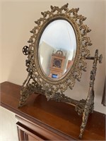 Ornate iron frame vanity mirrorThe mirror is