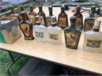 Collection of whiskey decanters with wildlife