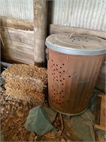 Burn barrel with lid and two small bales of straw